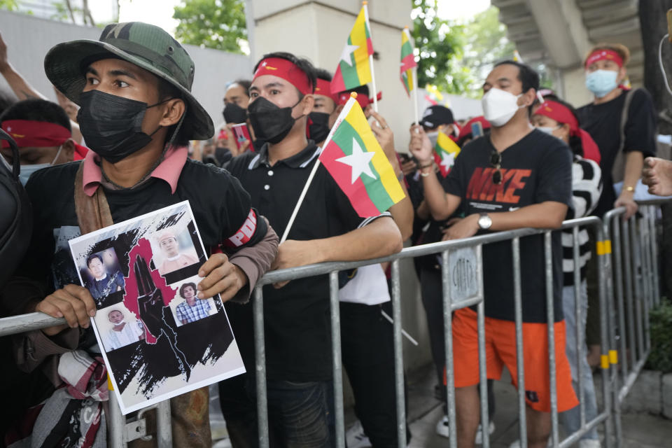 Myanmar nationals living in Thailand hold the pictures of the executed political prisoners in Myanmar, as they protest outside Myanmar's embassy in Bangkok, Thailand, Tuesday, July 26, 2022. International outrage over Myanmar’s execution of four political prisoners is intensifying with grassroots protests and strong condemnation from world governments. (AP Photo/Sakchai Lalit)