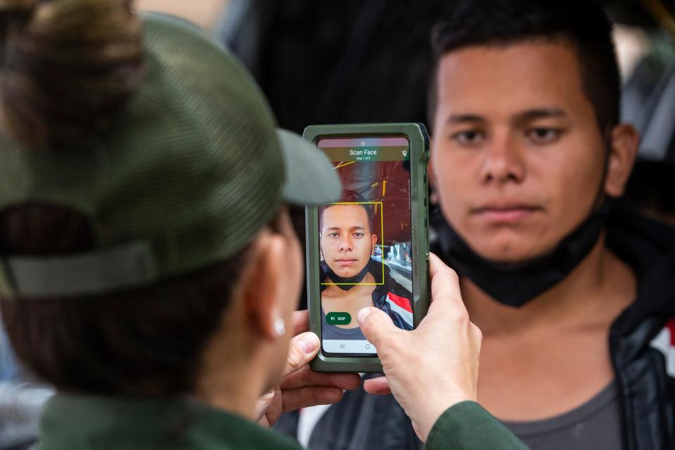 A Colombian migrant is registered by a Customs and Border Protection officer at a mobile processing center in El Paso, Texas after crossing the Rio Grande from Ciudad Juárez on Oct. 17, 2022.