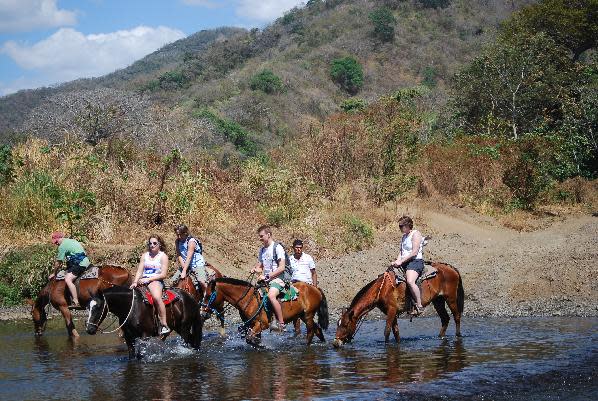 This February 2014 photo released by Kristina MacKulin shows a group of horseback riders on a tour with outfitters Nosara Paradise Rentals, in Nosara, Costa Rica. Nosara is a scenic coastal region with a variety of outdoor recreation activities for visitors. (AP Photo/Kristina MacKulin)