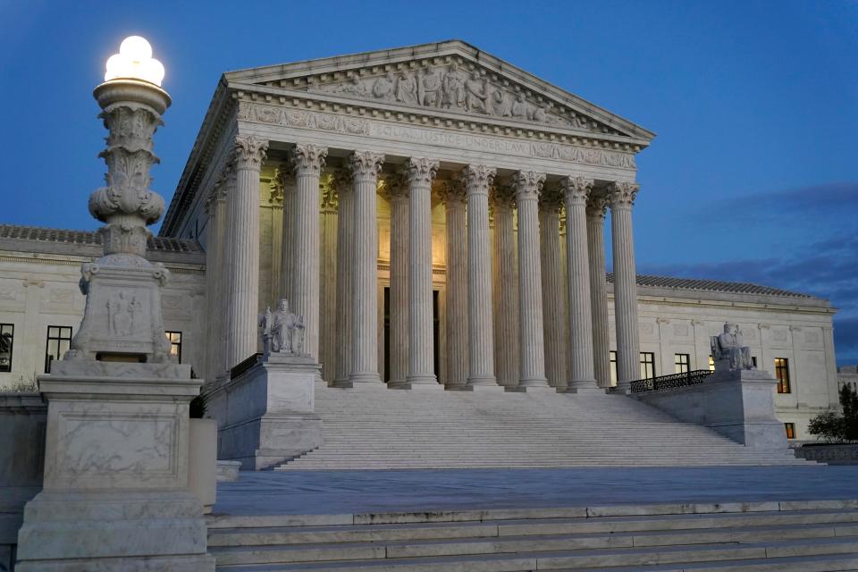Light illuminates part of the Supreme Court building at dusk on Capitol Hill in Washington.