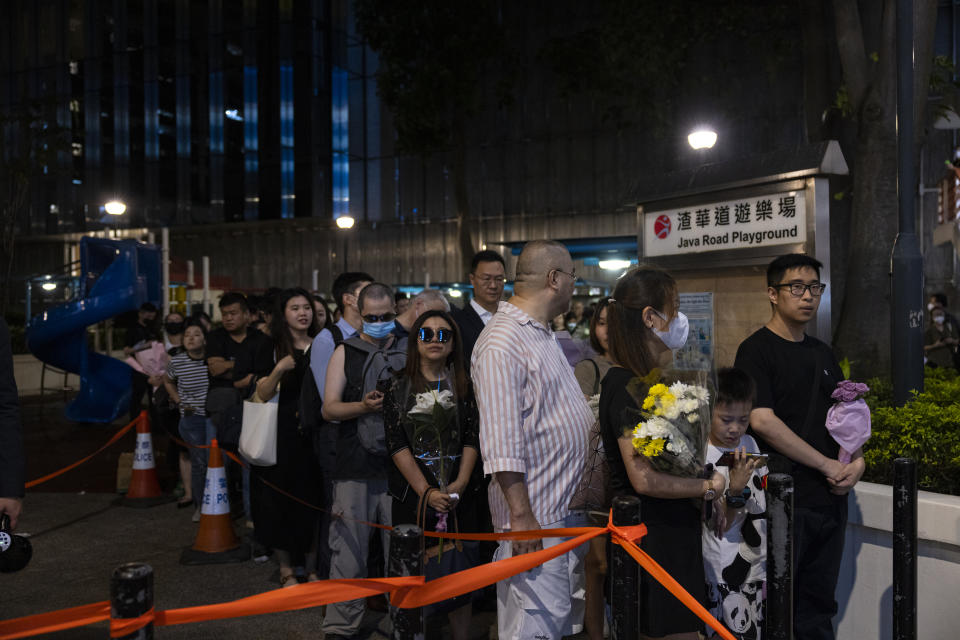 Members of the public line up to pay their respect for singer and songwriter Coco Lee outside a funeral home in Hong Kong, Monday, July 31, 2023. Lee died July 5 at age 48. (AP Photo/Louise Delmotte)