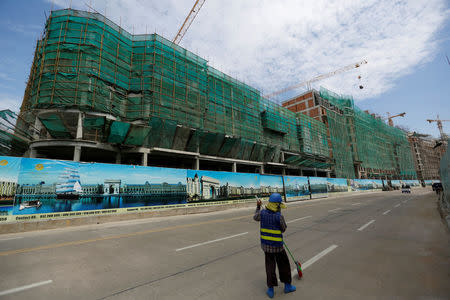 A construction worker cleans at the construction side in Diamond Island also known as 'Koh Pich' in Phnom Penh, Cambodia, May 23, 2018. Picture taken May 23, 2018. REUTERS/Samrang Pring