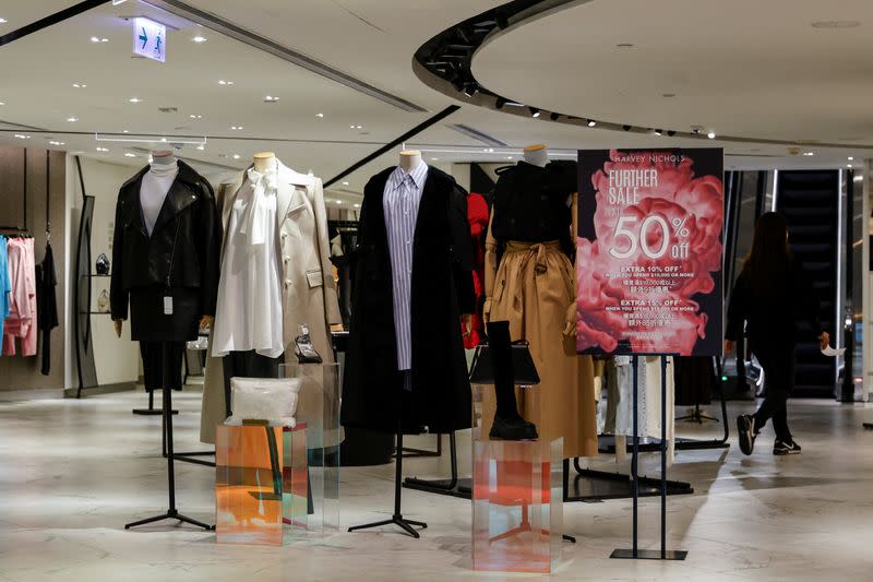 A woman walks inside Harvey Nichols, a London-headquartered multi-brand luxury retailer, at Landmark, the upscale shopping mall, in Hong Kong