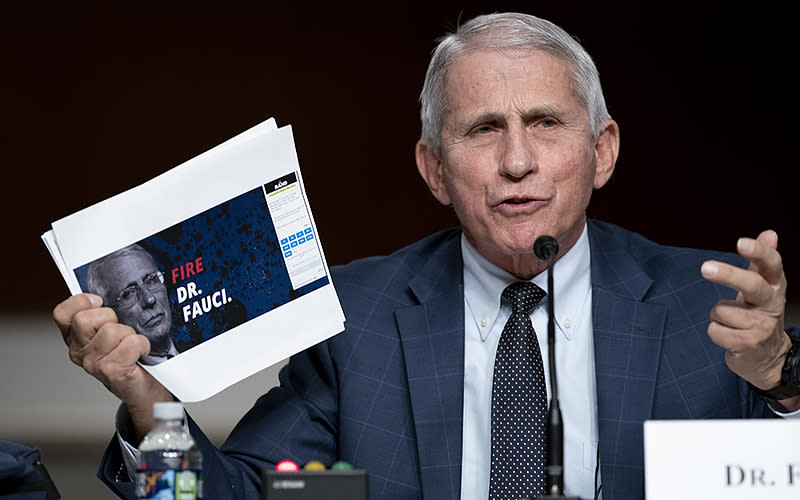 White House chief medical adviser Anthony Fauci shows a screen grab of a campaign website while answering questions from Sen. Rand Paul (R-Ky.) during a Senate Health Committee hearing to discuss COVID-19 on Jan 11. <em>Greg Nash</em>