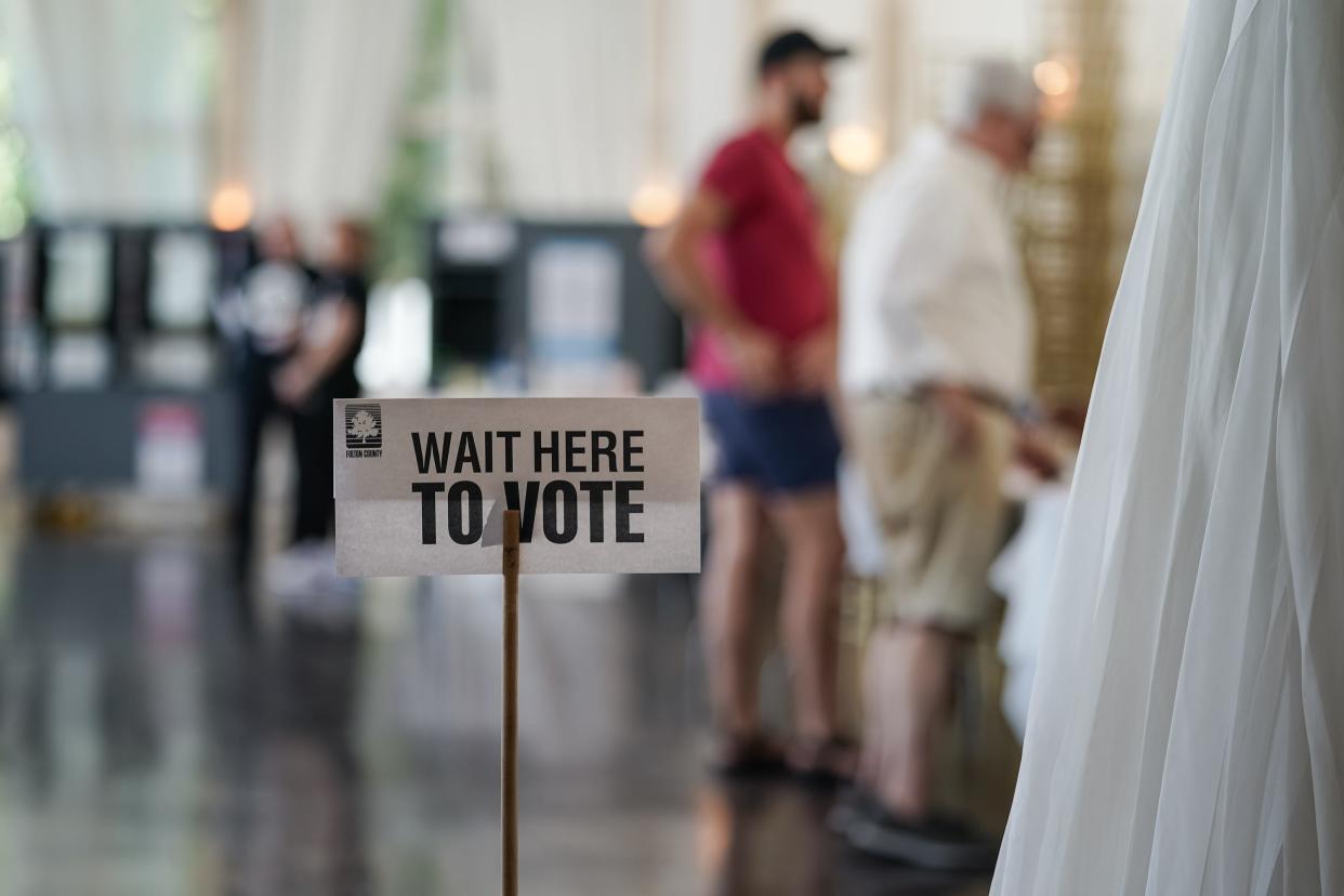 ATLANTA, GEORGIA - MAY 21: A 'Wait Here To Vote' sign is seen in a polling location as cvoters check in to cast ballots on May 21, 2024 in Atlanta, Georgia. Among the races on the ballot in Fulton County are Scott McAfee, the Fulton County Superior Court Judge overseeing former president Donald Trump's election interference criminal trial, and Fulton County District Attorney Fani Willis, who is prosecuting the case. (Photo by Elijah Nouvelage/Getty Images) ORG XMIT: 776149030 ORIG FILE ID: 2153450834