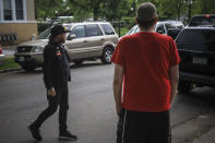 Michael Grunke, right, and his neighbor Obediah suspiciously checks a speeding pickup while on a neighborhood watch, which started after the death of George Floyd while in custody of police sparked unrest, Tuesday June 2, 2020, in Minneapolis, Minn. A week of civil unrest has led some Minneapolis residents near the epicenter of the violence to take steps to protect their homes and neighborhoods. (AP Photo/Bebeto Matthews)