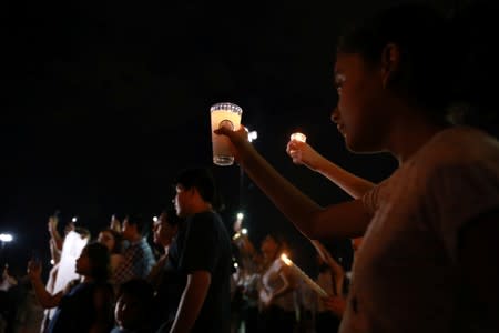 Mourners take part in a vigil near the border fence between Mexico and the U.S after a mass shooting at a Walmart store in El Paso U.S. in Ciudad Juarez