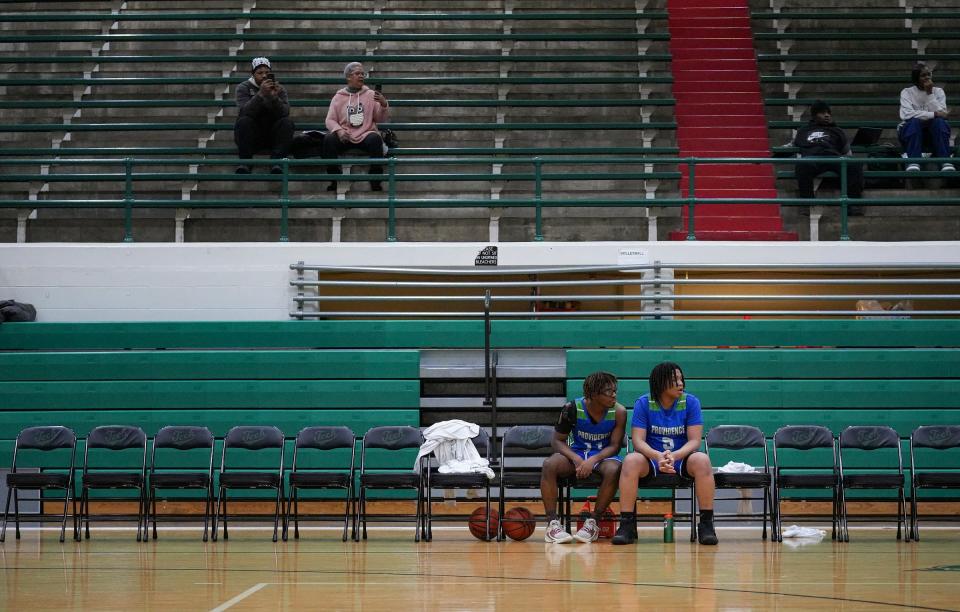 Providence Cristo Rey's Jason Morris, left, and Andrew Murphy watch game action from the bench Tuesday, Jan. 16, 2024, at Arsenal Technical High School. "If you watch the movie 'Hoosiers,' there were a couple nights where he said, 'hey, there's my four guys, we're going to go with those four guys on the floor,'" coach Scott Miller said. "We've come close to that the first half of the season, so it is kind of a Hoosiers story, almost 40 years later."