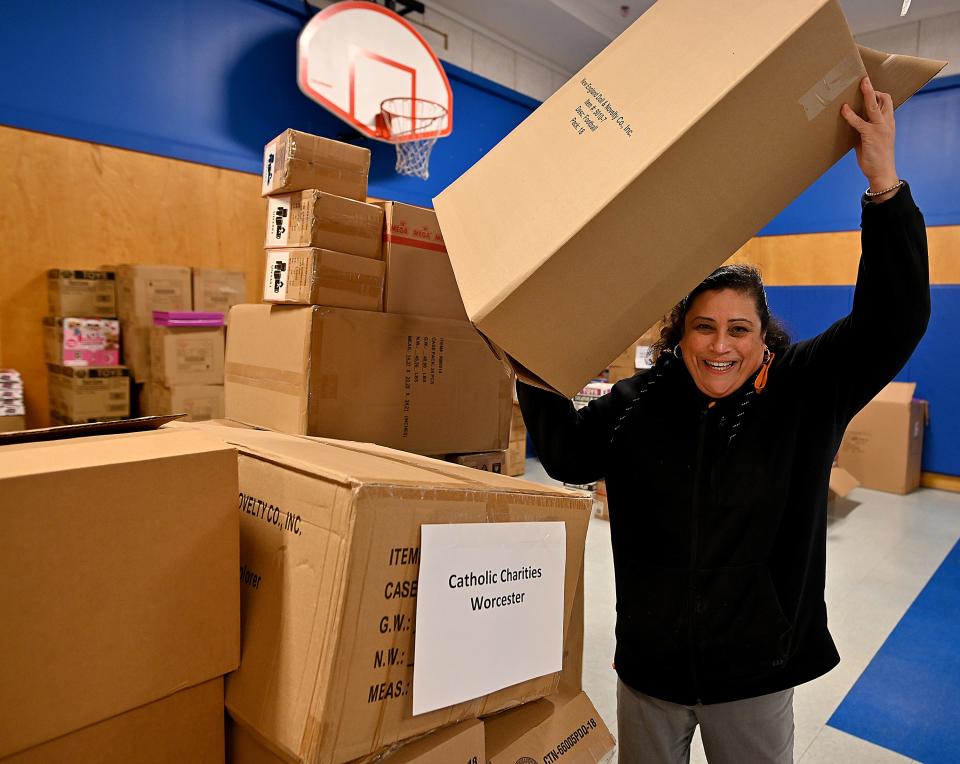 Maritza Delacruz, with the Catholic Charities Worcester County, picks up the gifts from the Salvation Army to be distributed to kids as part of the T&G Santa Fund.