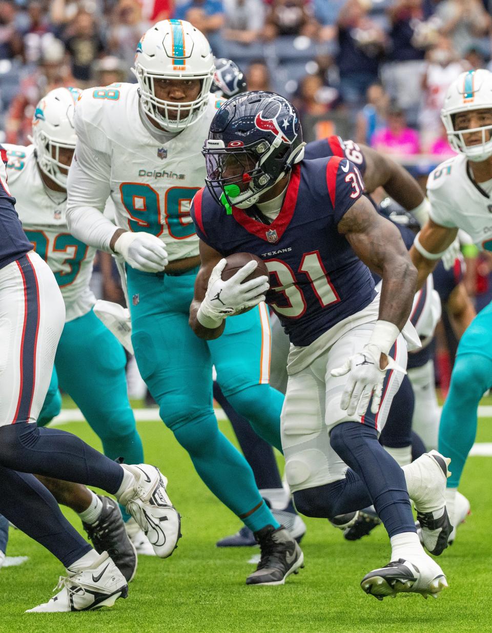 Aug 19, 2023; Houston, Texas, USA; Houston Texans running back Dameon Pierce (31) rushes against Miami Dolphins defensive tackle Brandon Pili (96) in the first quarter at NRG Stadium. Mandatory Credit: Thomas Shea-USA TODAY Sports