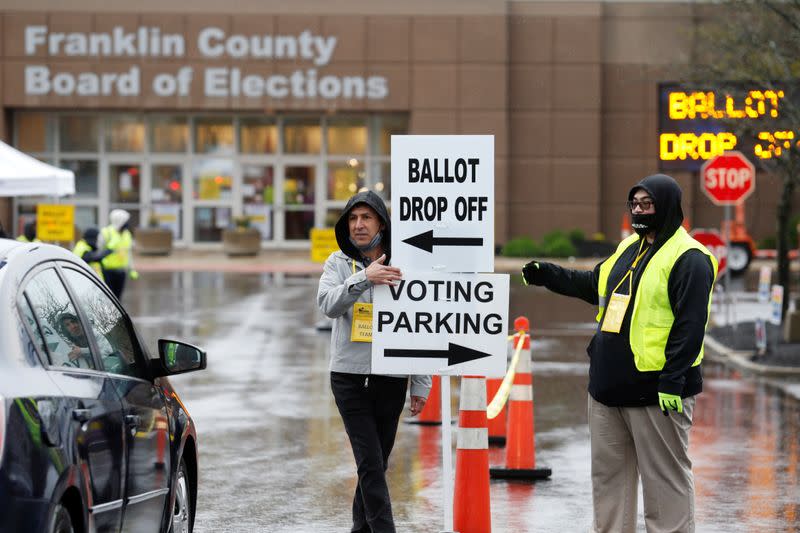 Voters line up to cast their ballots for the presidential primary elections in Columbus