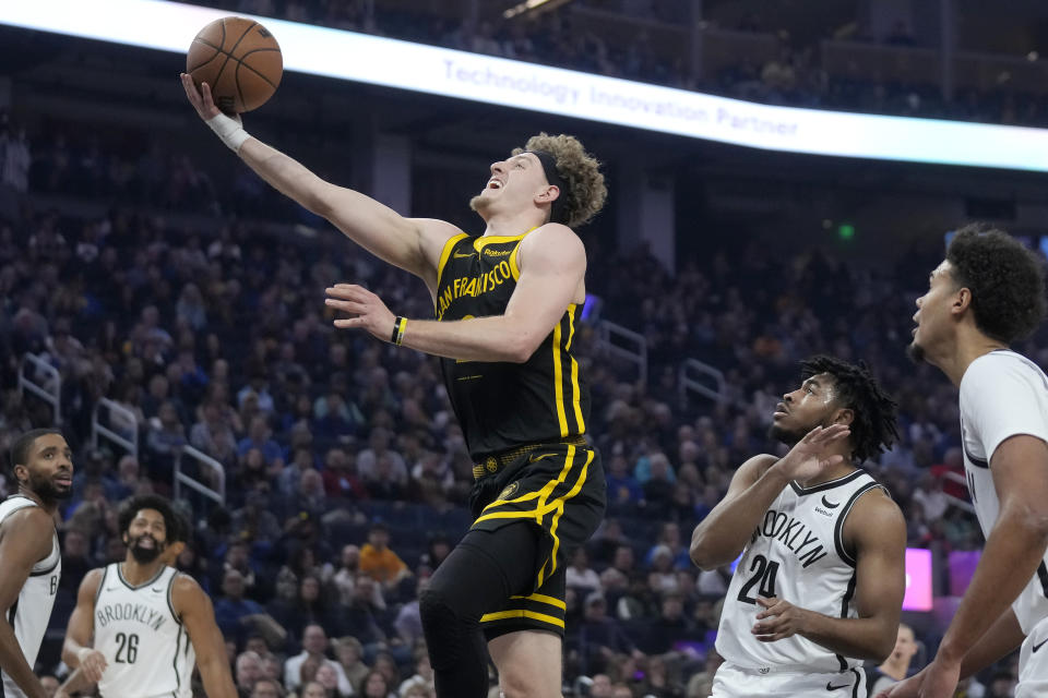 Golden State Warriors guard Brandin Podziemski shoots against the Brooklyn Nets during the first half of an NBA basketball game in San Francisco, Saturday, Dec. 16, 2023. (AP Photo/Jeff Chiu)