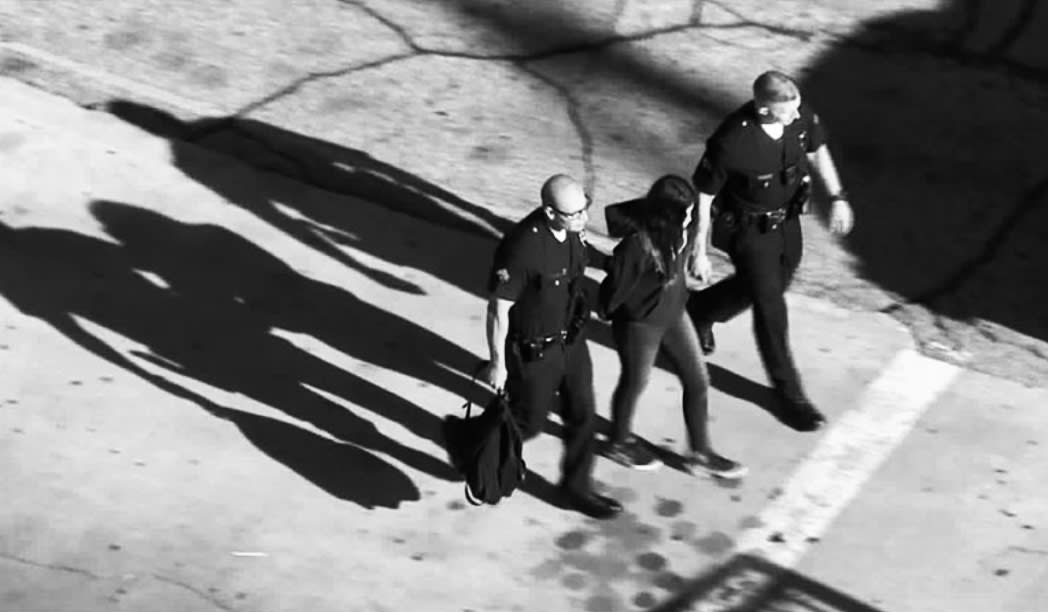 A student is led away by law enforcement officers after four students were injured in Thursday’s shooting incident at Sal Castro Middle School in Los Angeles. (Photo: KTLA screenshot)