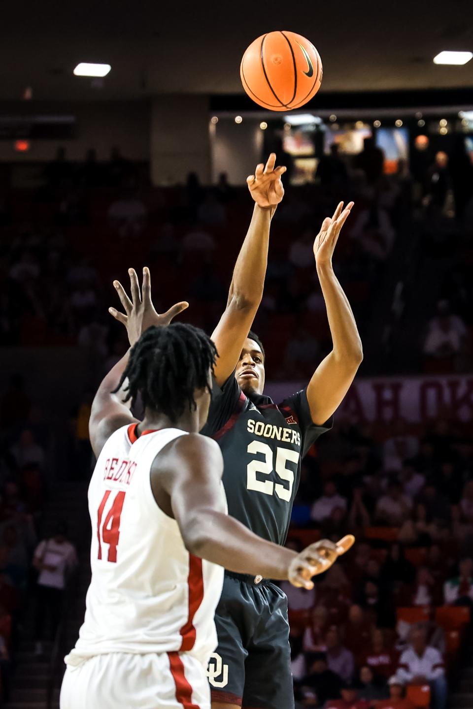 OU's Grant Sherfield (25) shoots a 3-point over Alabama's Charles Bediako (14) in the first half on Saturday.