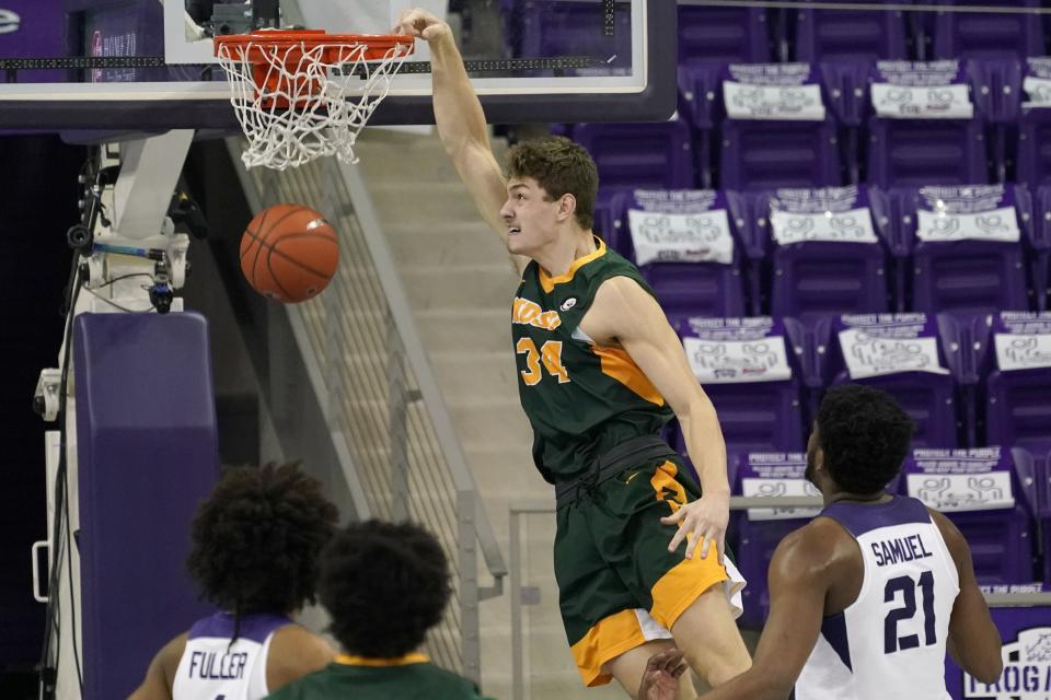 North Dakota State forward Rocky Kreuser (34) dunks as TCU's PJ Fuller, bottom left, and Kevin Samuel (21) watch during the second half of an NCAA college basketball game in Fort Worth, Texas, Tuesday, Dec. 22, 2020. (AP Photo/Tony Gutierrez)