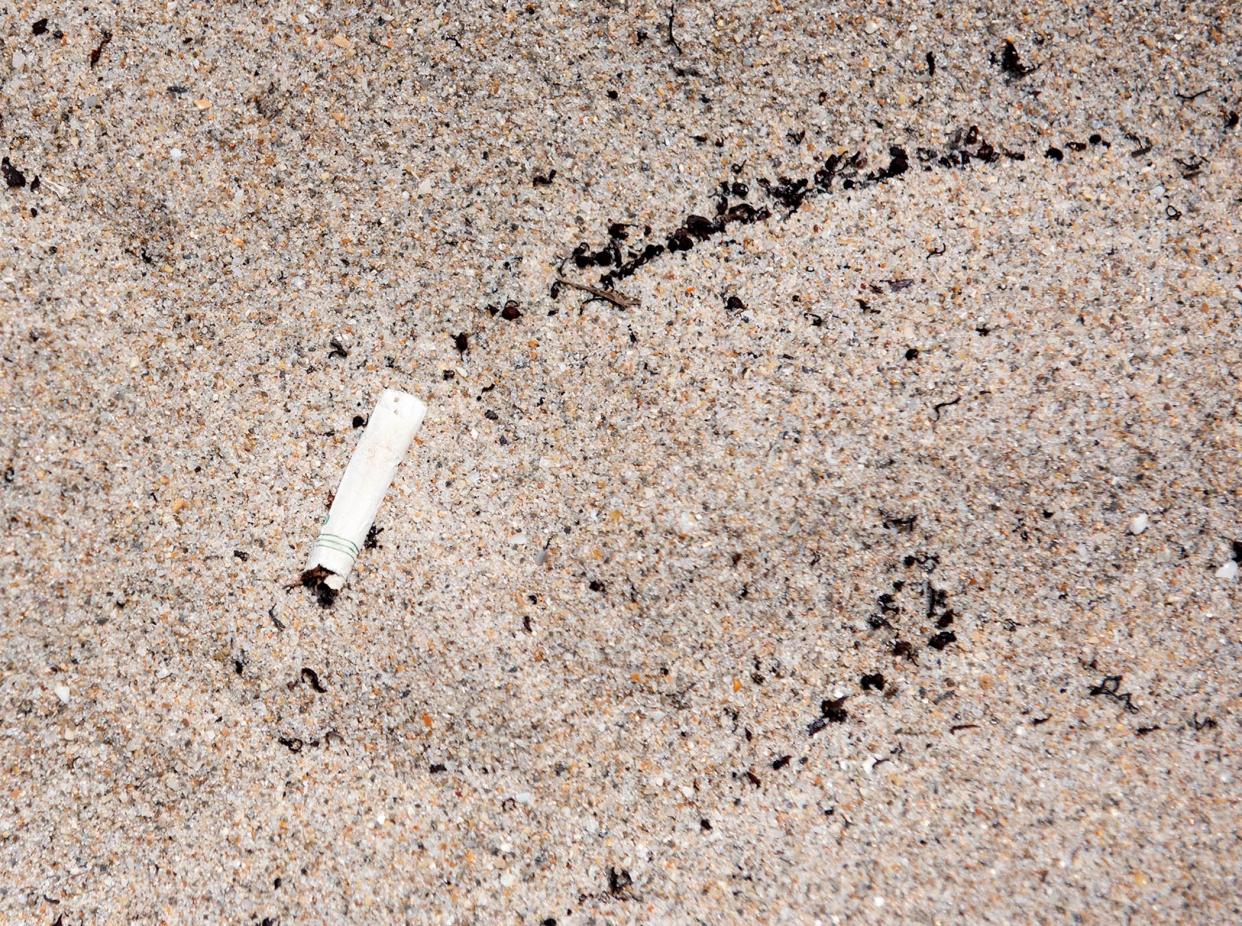 A cigarette butt is left on the sand at R. G. Kreusler Park in Palm Beach July 8, 2022. MEGHAN MCCARTHY/The Palm Beach Daily News