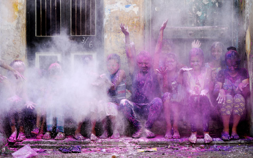 Afin de célébrer la Holi, parfois appelée fête des couleurs en Inde, des enfants s'amusent à lancer des pigments de couleurs. (Photo : ARUN SANKAR / AFP)