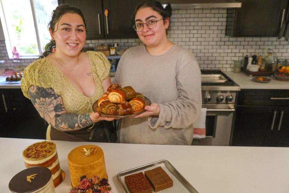 Kristine Jingozian, left, and Rose Jingozian, right, pose for a portrait while holding nazooks.