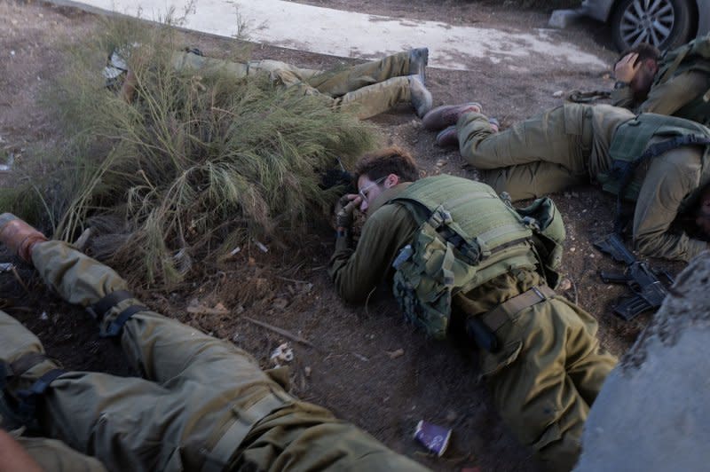 Israeli infantry soldiers hit the dirt and take cover during a "red alert" inside the Gaza Strip as Hamas fires a rocket toward the border community of Nir Am on Tuesday. Photo by Jim Hollander/UPI