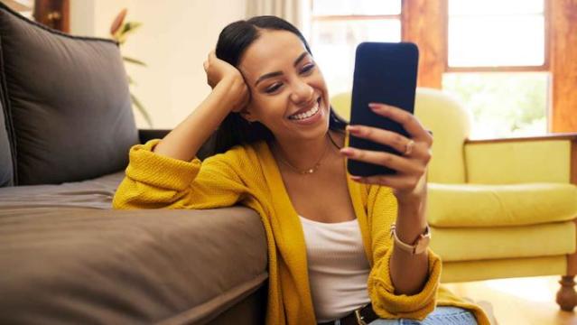 Smiling Woman Looking At Shirt While Shopping In A Clothing Store Stock  Photo - Download Image Now - iStock