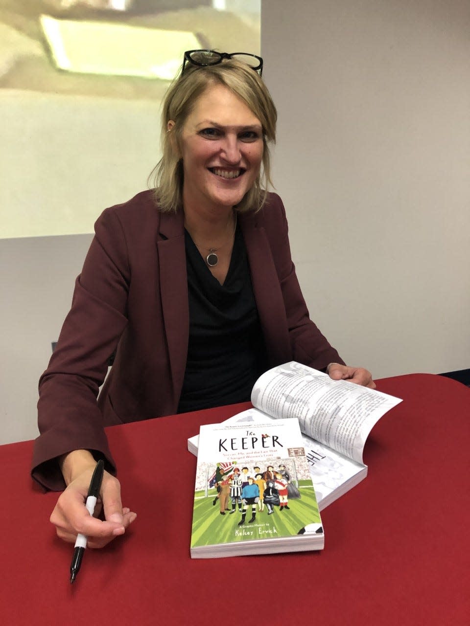 Writer Kelcey Ervick signs books at a recent talk at IU South Bend, where she teaches creative writiing. Ervick’s book “The Keeper” tells the story of her journey playing soccer and the positive effect Title IX  has had on her life. 

Photo by Kathy Borlik