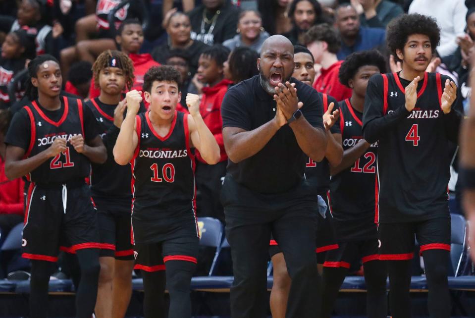 William Penn, including head coach Gary Lumpkin and players Rafiq Harvey (21), Ryan Ramirez Velez (10) and Dominic Smith react as the Colonials retake the lead with 6:32 to play in Salesianum's 64-55 win, Friday, Jan. 12, 2024 in Wilmington.