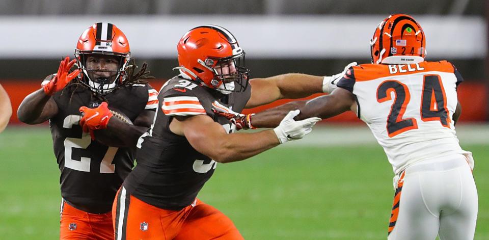 Cleveland Browns fullback Andy Janovich (31) blocks Cincinnati Bengals safety Vonn Bell (24) as Browns running back Kareem Hunt (27) rushes for a first down on Sept. 17, 2020.