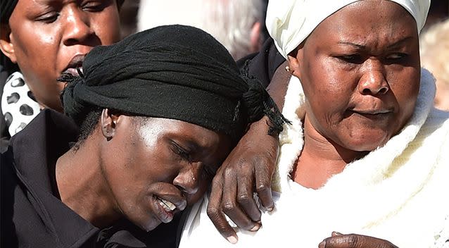 Akon Guode (left), pictured at the funeral service for her children at St Andrews Catholic in Werribee on April 18, 2015. Photo: AAP