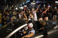 FILE - In this June 15, 2021, file photo, fans of France's team celebrate their side's victory after the Euro 2020 soccer championship group F match between France and Germany, in Marseille, southern France. In France, authorities said it’s no longer always mandatory to wear masks outdoors and said they would end a nightly coronavirus curfew this weekend. (AP Photo/Daniel Cole, File)