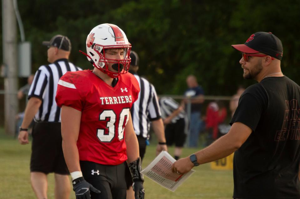 Coach Michael Langhann talks to the defense as the Terriers look to iron out the smaller details before Week 1.