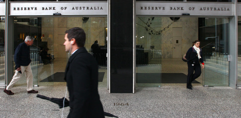 People walk past the Reserve Bank of Australia in Sydney, Tuesday, June 5, 2012. Australia's central bank has cut its benchmark interest rate for a second consecutive month, lowering it a quarter percentage point to 3.5 percent. (AP Photo/Rick Rycroft)