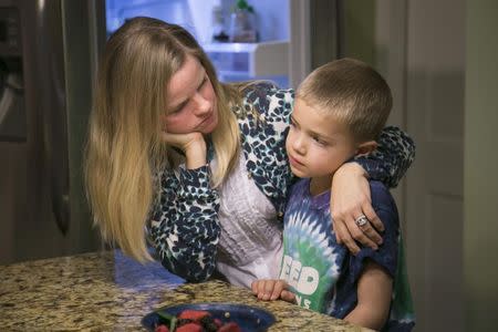 Jodi Krawitt holds her son Rhett, 6, in their home in Corte Madera, California January 28, 2015. Rhett is recovering from leukemia and his father is concerned his child could succumb to an outbreak of measles at his Northern California school. Krawitt is asking officials to bar entry to any student not vaccinated because of a family's personal beliefs. REUTERS/Elijah Nouvelage