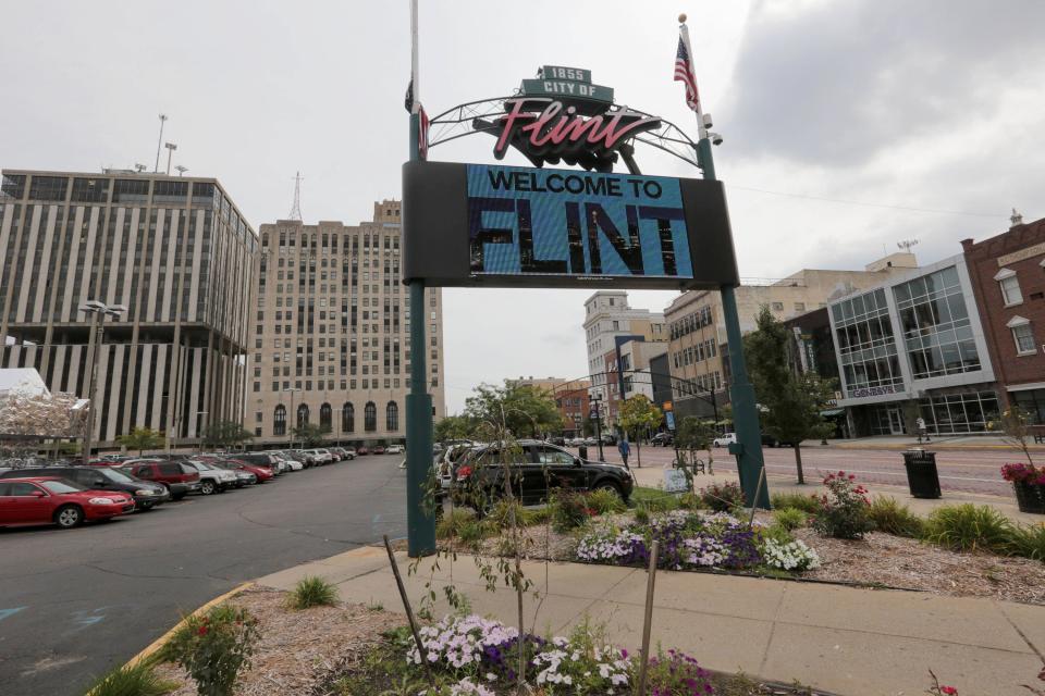 A video sign flashes a Welcome to Flint sign off of Saginaw Street in downtown Flint in September 2013.