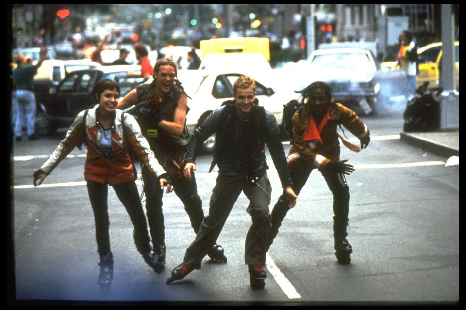 <p>Roller blading through busy streets with her <em>Hackers</em> costars in 1995.</p>