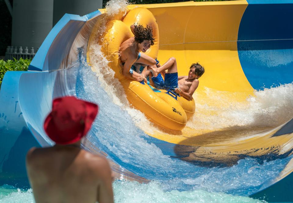 Makai Craine and his brother Braxton Craine cool off on a slide at the Rapids Rapids Waterpark in Riviera Beach, Florida June 14, 2023.