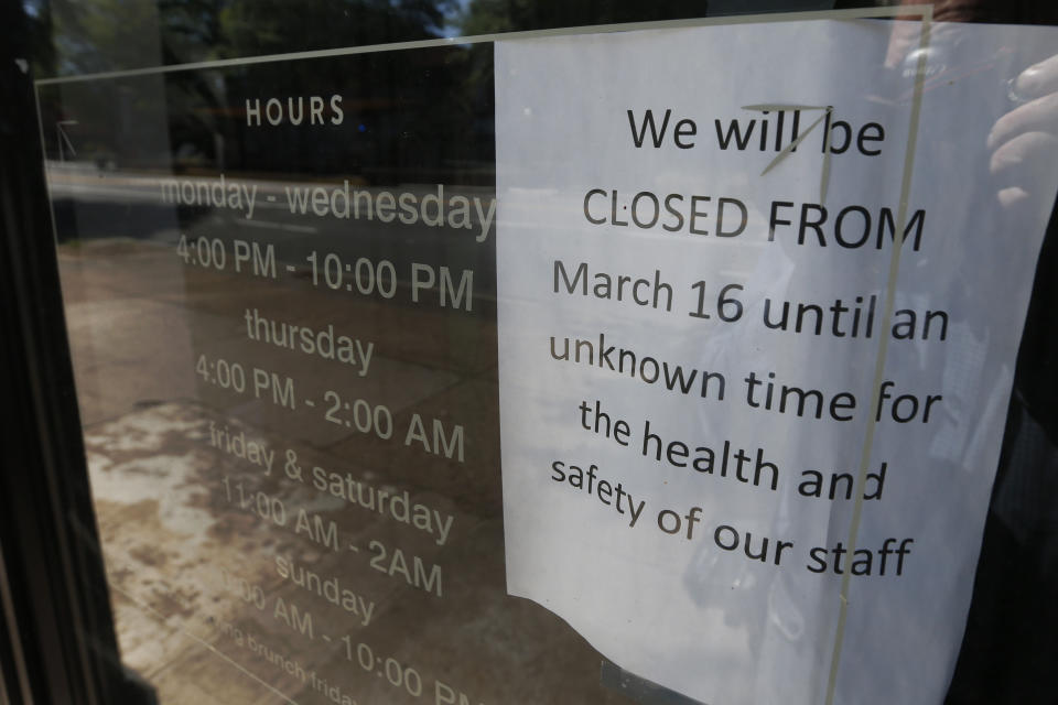 A sign on the front door of the closed Tarrant's Café restaurant Thursday May 7, 2020, in Richmond, Va. The restaurant group that owns Tarrant's Café and Bar Solita decided to close those locations and one other amid the coronavirus pandemic. Nearly 3.2 million laid-off workers applied for unemployment benefits last week as the business shutdowns caused by the viral outbreak deepened the worst U.S. economic catastrophe in decades. (AP Photo/Steve Helber)