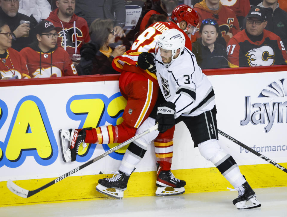 Los Angeles Kings defenseman Matt Roy, right, checks Calgary Flames forward Nazem Kadri during the second period of an NHL hockey game Tuesday, March 28, 2023, in Calgary, Alberta. (Jeff McIntosh/The Canadian Press via AP)