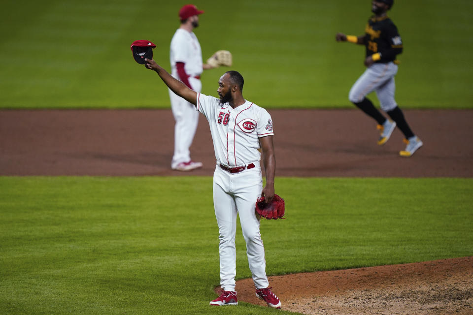 Cincinnati Reds relief pitcher Amir Garrett (50) tips his cap in the direction of the Pittsburgh Pirates' dugout after the Reds defeated the Pirates 4-1 in a baseball game in Cincinnati, Tuesday, Sept. 15, 2020. (AP Photo/Bryan Woolston)