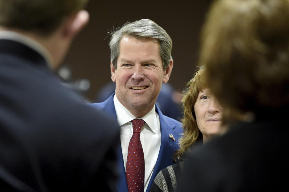 Georgia Governor-elect Brian Kemp, middle, poses for photos with supporters during a stop in Augusta, Ga., as part of what he calls his "thank-you tour" Wednesday Jan. 9, 2019. Kemp says he plans to focus his first year in office on helping small businesses, cutting taxes and cracking down on violent gangs. (Michael Holahan/The Augusta Chronicle via AP)