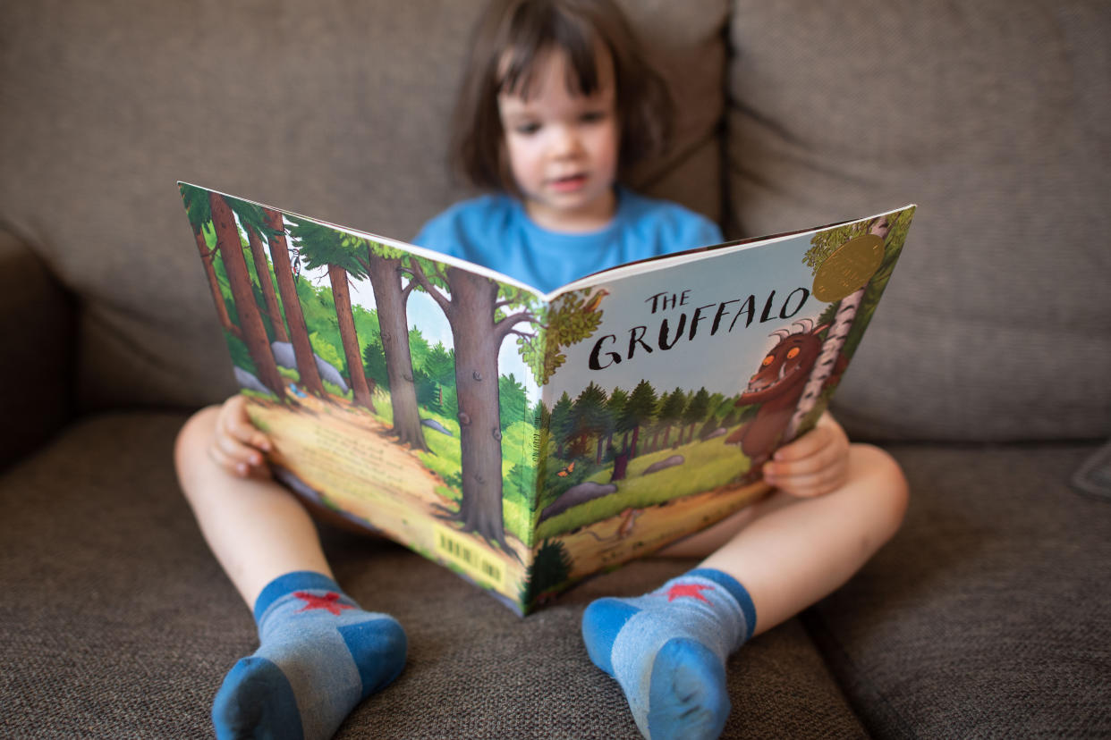 A child reads a copy of ‘The Gruffalo’, at home in London. (PA/Matt Crossick/Empics)