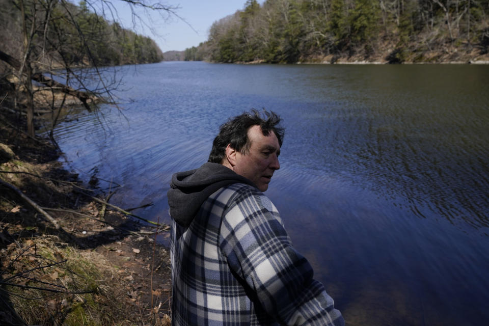 Michael Vallarella shows reporters a section of the Esopus Creek near his house in Saugerties, N.Y., Tuesday, April 5, 2022. As western regions contend with drier conditions, New York City is under fire for sometimes releasing hundreds of millions of gallons of water a day from the Ashokan reservoir in the Catskill Mountains. The occasional releases, often around storms, have been used to manage water the reservoir's levels and to keep the water clear. But residents downstream say the periodic surges cause ecological harm along the lower Esopus Creek. (AP Photo/Seth Wenig)