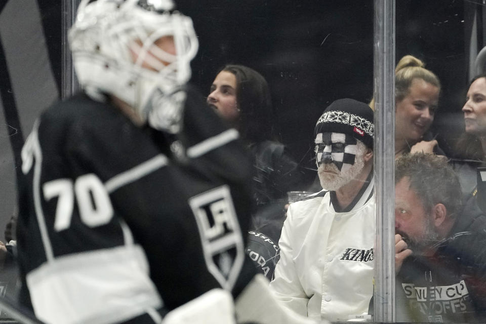 Actor Will Ferrell, second from right, watches as Los Angeles Kings goaltender Joonas Korpisalo skates by during the first period in Game 3 of an NHL hockey Stanley Cup first-round playoff series between the Kings and the Edmonton Oilers Friday, April 21, 2023, in Los Angeles. (AP Photo/Mark J. Terrill)