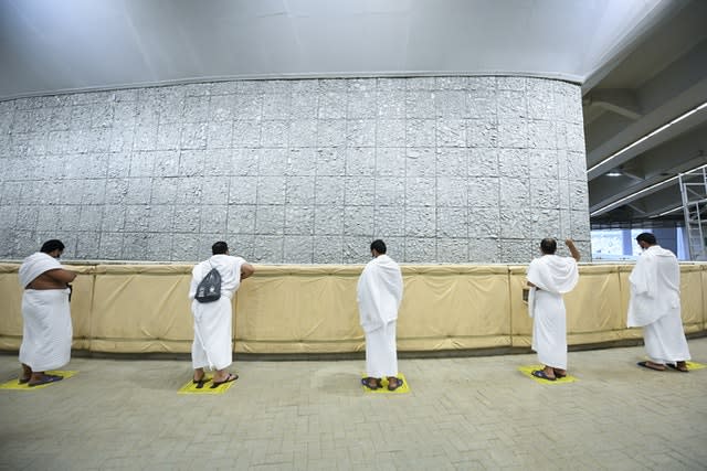 Muslim pilgrims cast stones at a pillar in the symbolic stoning of the devil