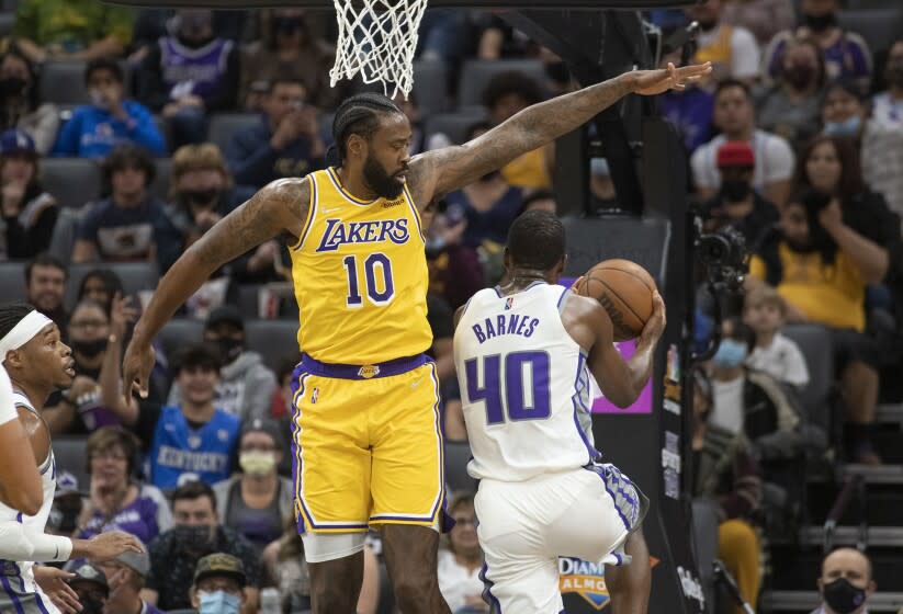 Los Angeles Lakers center DeAndre Jordan (10) defends the basket against Sacramento Kings forward Harrison Barnes (40) during the first quarter of an NBA basketball game in Sacramento, Calif., Thursday, Oct. 14, 2021. (AP Photo/Randall Benton)