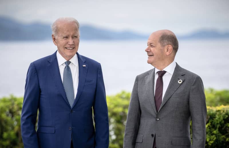 Joe Biden (L), President of the USA, and German Chancellor Olaf Scholz (SPD), pose for a group photo of the heads of state and government of the G7 countries before their working lunch on economic security during the G7 summit at the Grand Prince Hotel in Hiroshima, western Japan. They will meet in Washington on Friday. Michael Kappeler/dpa