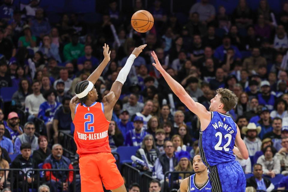 Thunder guard Shai Gilgeous-Alexander (2) shoots over Magic forward Franz Wagner (22) during the second quarter Tuesday night in Orlando, Florida.
