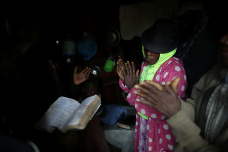 Believers gather to pray inside a house in Boucan Ferdinand, Haiti, April 6, 2018. REUTERS/Andres Martinez Casares