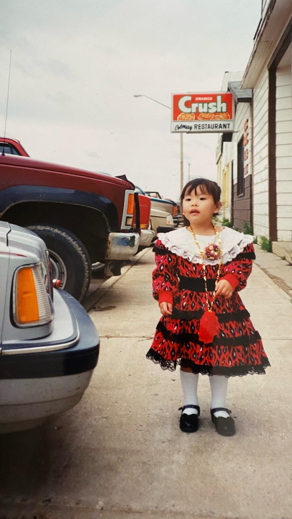 Venessa Liang stands in front of the restaurant her family owned in Colonsay, Sask. Liang says most of her memories from childhood are of the restaurant. (Submitted by Venessa Liang - image credit)