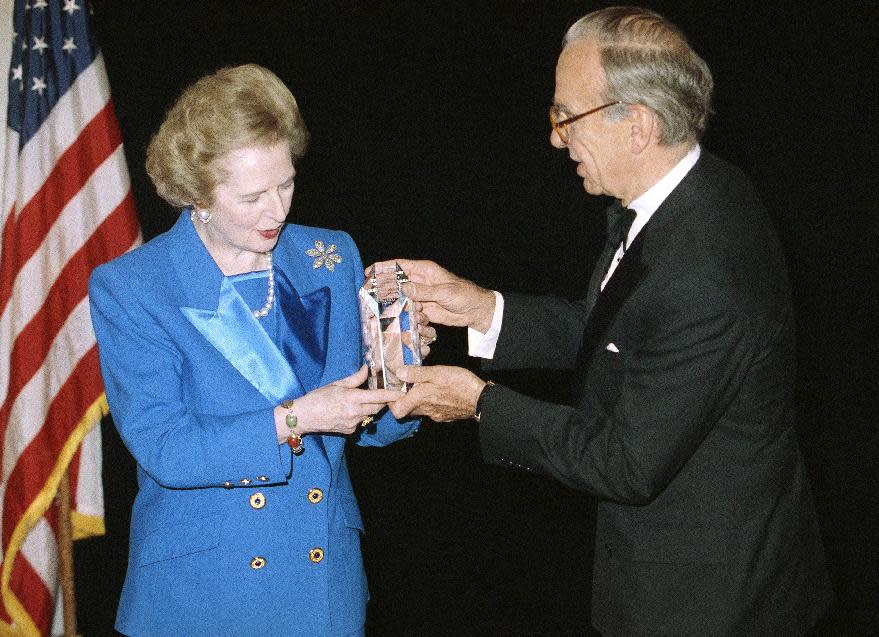 FILE - In this Nov. 14, 1991, file photo, Margaret Thatcher accepts the United Cerebral Palsy of New York's 37th Annual Humanitarian Award in New York from Rupert Murdoch. (AP Photo/Mike Albans, File)