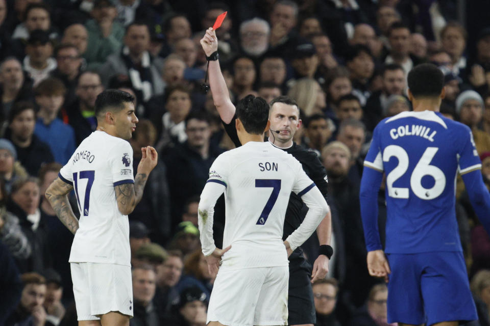 Referee Michael Oliver shows a red card to Tottenham's Cristian Romero during the English Premier League soccer match between Tottenham Hotspur and Chelsea, at Tottenham Hotspur Stadium, London, Monday, Nov. 6, 2023. (AP Photo/David Cliff)